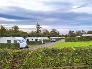 Peaceful setting with coastal views from some touring pitches