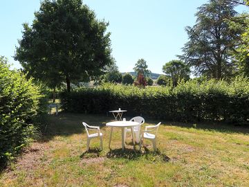 Grass pitch surrounded by hedges for privacy