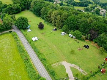 Spacious, large grass pitches at cherry tree glamping - aerial view of touring park