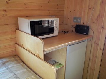Microwave and fridge inside the pod