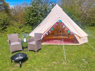 Superior bell tent with outdoor chairs and firepit