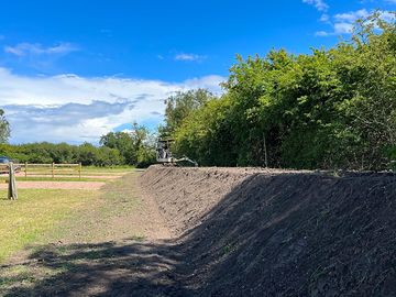 Soil bund being shaped ready for seeding