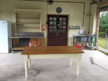 Communal barn with food prep and washing-up area, with bathroom in internal room