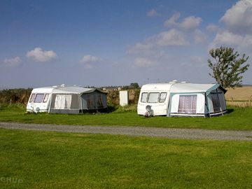 Touring field with open countryside to the rear.
