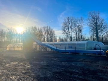 Pool with waterslide and retractable cover