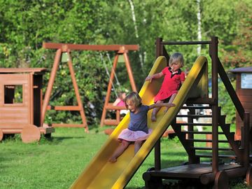 Swings and slides in the play area