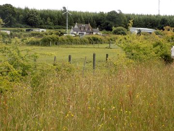 Looking across the fields and up to brachla house from the walk/play area
