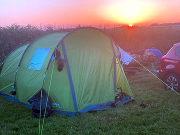 Tent with the beautiful sunset in the distance