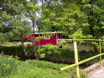 The red gypsy caravn by the river