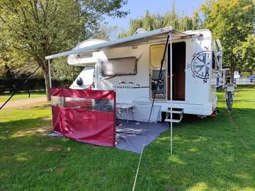 Generous serviced grass pitch.