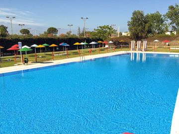 Pool and sun deck with umbrellas
