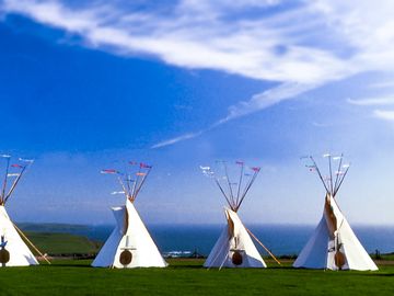 Tipis sitting in a row above Bedruthan Steps (added by manager 11 May 2021)