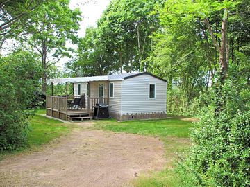 Static caravan tucked among the trees