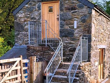 Toilet and shower up stone steps in the converted barn