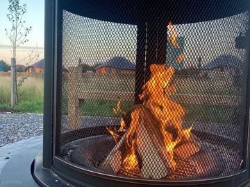 Communal fire pit is close to the wooden yurts