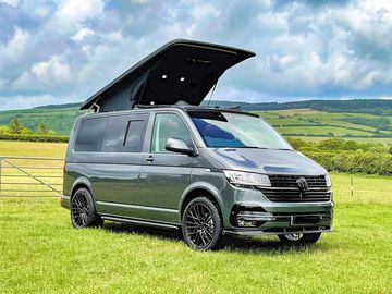 Vw poptop on the grass campervan pitch