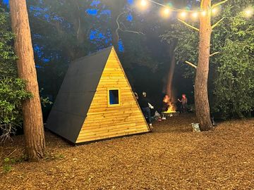 The Teepee with people enjoying a fire pit