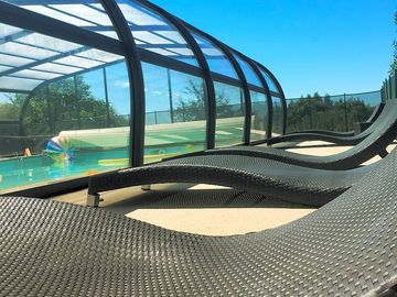 Sun loungers outside the swimming pool
