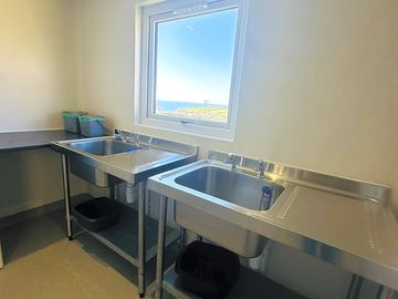 The wash up room with a fridge, a freezer and a beautiful view!