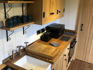 Kitchen with cooker, microwave and sink