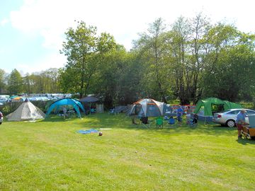 A group pitched together in a corner of the rally field