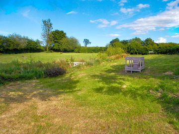 Grass pitches surrounded by greenery