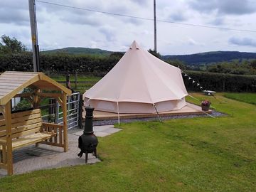 The bell tent with bench seating and chiminea
