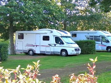 Pitches divided by hedges and backed by trees