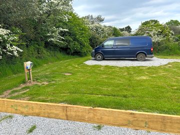 Gravel pitch with grass to side and hook up