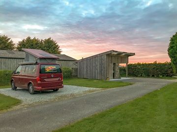 Sunset behind one of the hard-standing pitches and the washup/laundry block