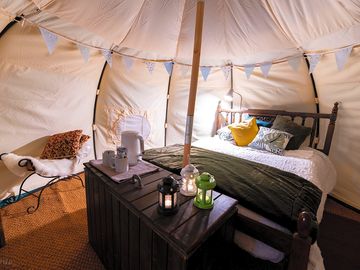 Luxury glamping bell tents, furnished with a comfortable double bed and various cosy amenities