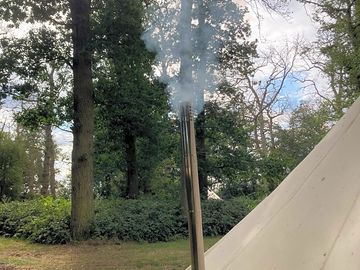 Woodburning stove with exterior chimney