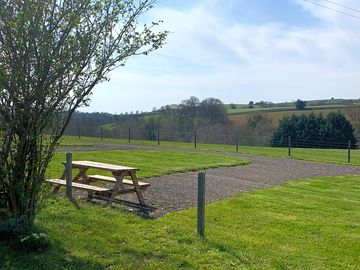 Hardstanding pitch and grass area.
