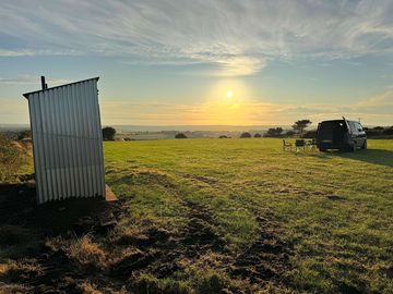 Long drop compost toilets at top of campsite