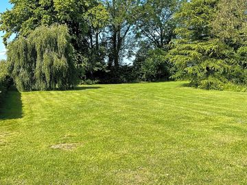 Level grass pitches sheltered by trees