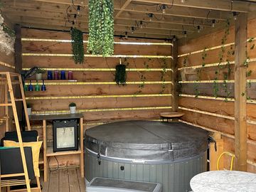 New greenery added above and around the hot tub.