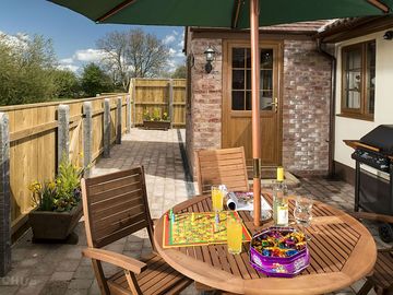 Table, chairs and barbecue in the patio garden