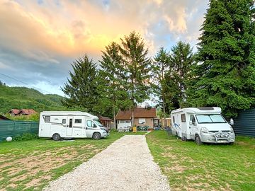 Rural campsite backed by trees and hills
