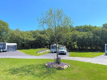 Fully-serviced hardstanding with grass pitch