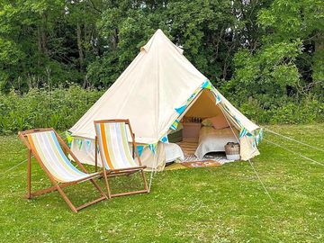 Belle tent surrounded by greenery