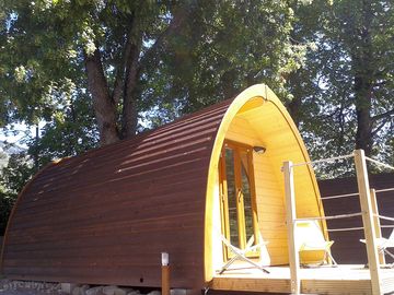 Camping pod shaded by trees