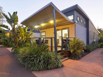 Exterior of the bungalow lit at night