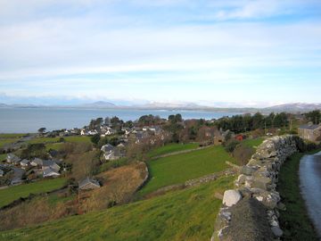 View of llanfair village and criccieth over the sea