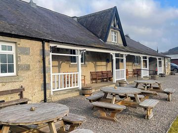 Picnic tables at the front of the public hall