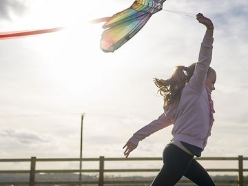Child running with a kite