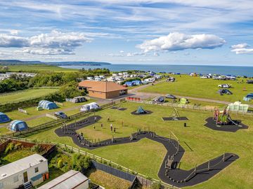 Childrens Play Area with camping field and upper touring caravan area in the background.