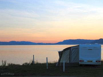 Enjoy the sunset over the distant mountains whilst having a barbecue on the beach