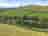 Dartmoor Halfway Inn: View of the site from hill, plenty of open green space on site