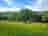Bridge Inn Camping Site: Visitor image of the campsite with the river on the left which backs onto the hard-standing sites