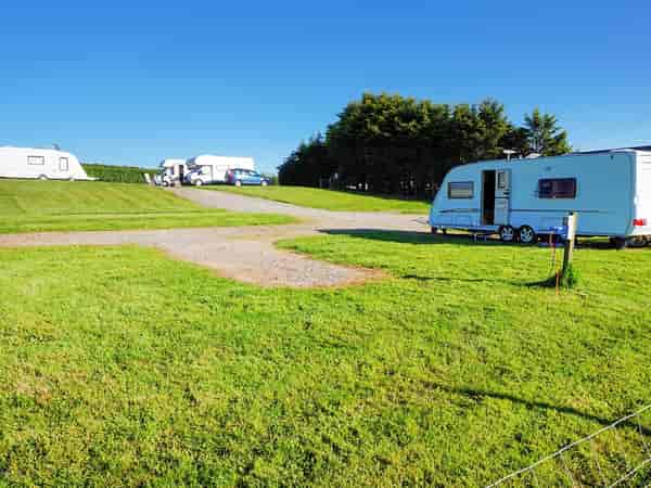 Electric hardstanding and grass touring pitch (2 adults and 2 children)